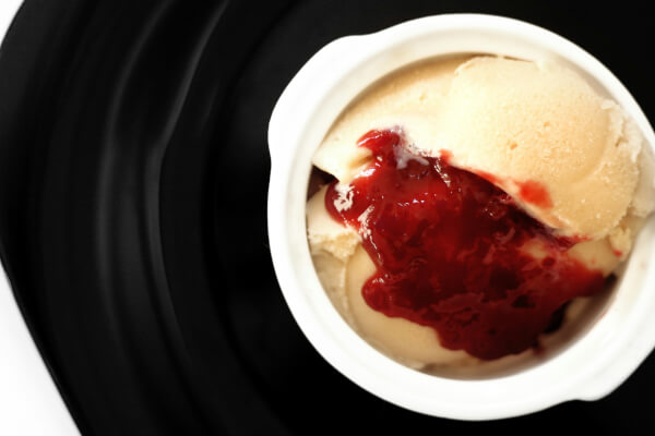 vanilla ice-cream with strawberry jam on the top